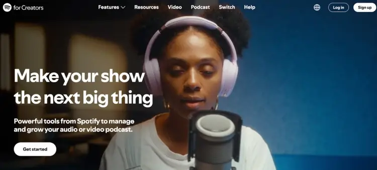 Spotify for Creators homepage showing a woman in headphones recording a podcast, highlighting free podcast recording and growth tools.