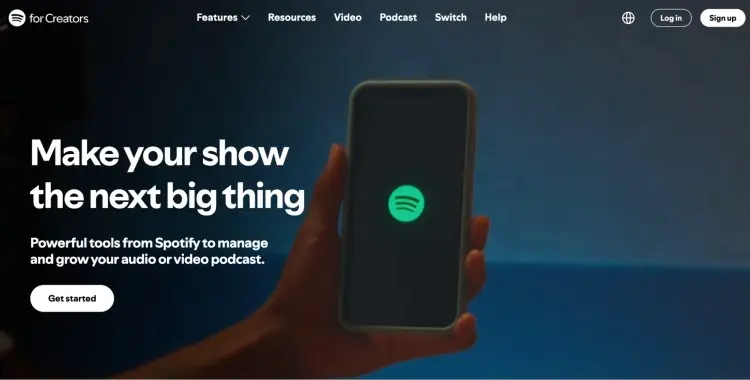 Homepage of Spotify for Creators featuring a phone screen with the Spotify logo, promoting tools to launch a podcast on Spotify.
