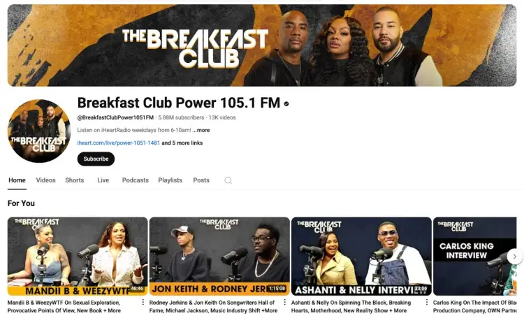 Screenshot of The Breakfast Club radio show’s official YouTube channel, featuring hosts Charlamagne Tha God, DJ Envy, and Angela Yee, with clips from celebrity interviews.