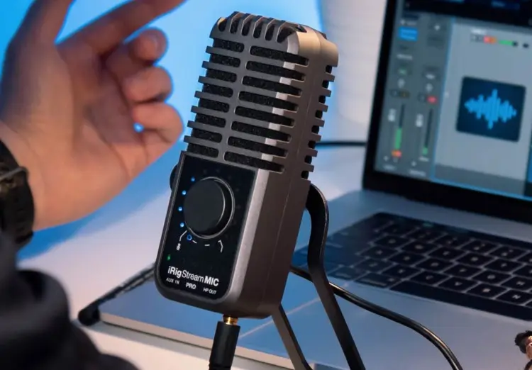 Close-up of the iRig Stream Mic Pro connected to a laptop, used for high sound quality recordings