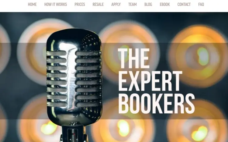 Close-up of a vintage microphone with glowing lights in the background and the text "The Expert Bookers," representing a podcast booking agency that helps experts get booked as a guest on shows.