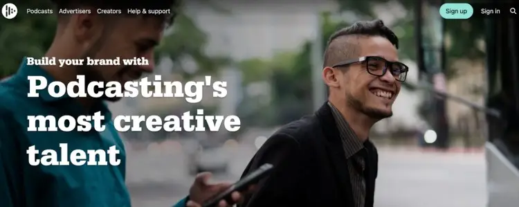 Screenshot of the Audioboom homepage showing two smiling creators, promoting the podcast platform as ideal for brands looking to collaborate with creative talent.