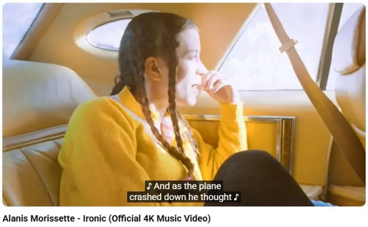 Scene from Alanis Morissette Ironic music video illustrating a type of verbal irony through contrasting expectations and unexpected outcomes.