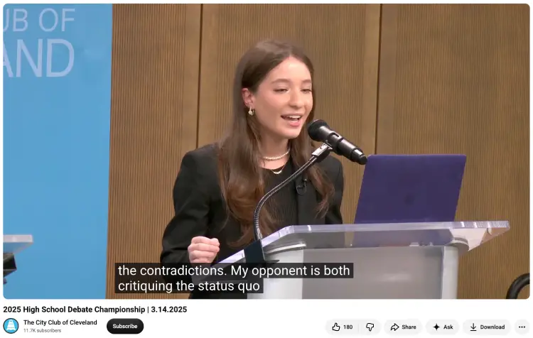 Student debater presenting pieces of evidence while making an argument at a high school debate championship
