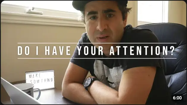 Speaker looking directly at the camera with the words “Do I Have Your Attention?” to illustrate full attention
