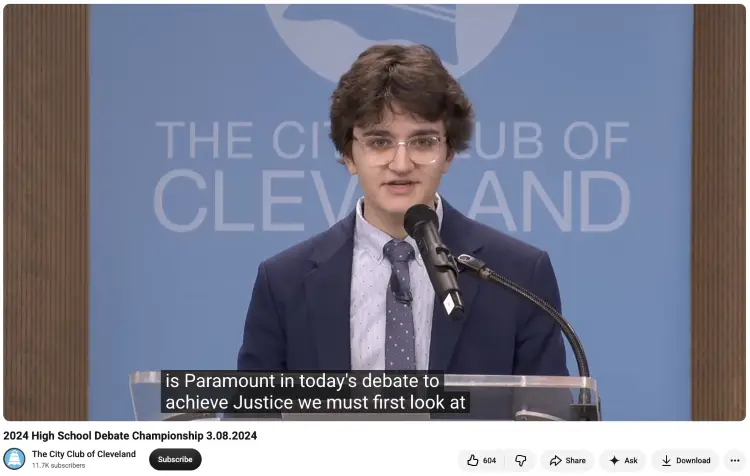 High school student at a podium learning to speak clearly during a formal debate