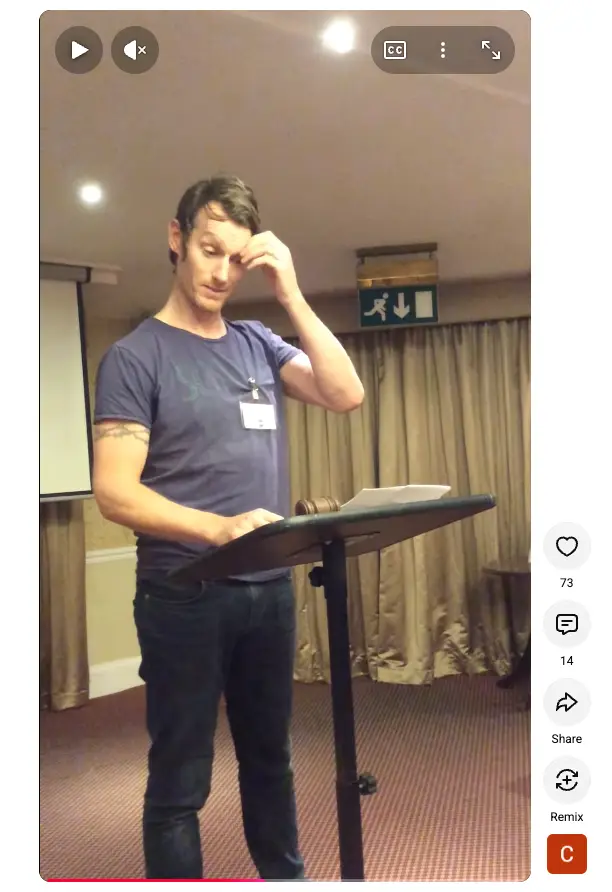 Speaker at a lectern appearing nervous or anxious while preparing to address a room