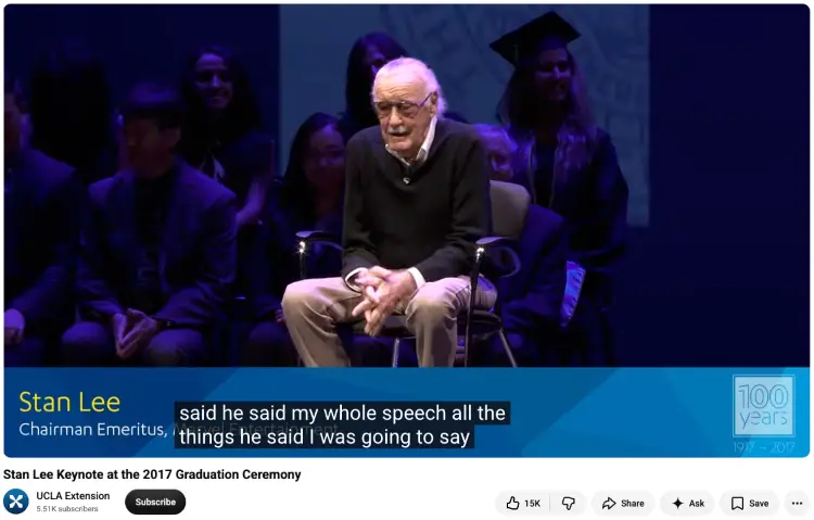 Stan Lee speaks to graduates while delivering a commencement address at a university graduation ceremony.