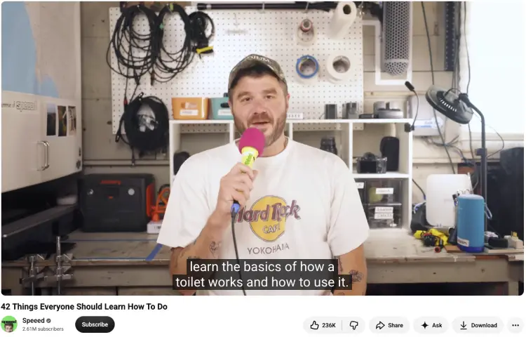 Video presenter holding a microphone in a workshop while sharing practical life skills and speaking tips through an educational presentation.
